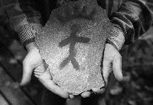 An ecotourist cradles a rock art reproduction