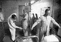 During cleanup at Rocky Flats, a radiation safety
technician checks workers for possible contamination