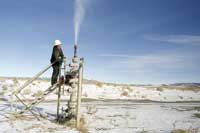 A worker releases a burst of gas, part of maintenance
operations among the sand dunes in the Jack Morrow Hills north of
Rock Springs, Wyoming