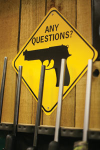 Rifles and a relevant sign at Red's