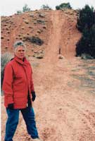 Lynell Schalk stands by an archaeological site marred with
off-road vehicle tracks despite the closed sign reading,
“Please don’t erase the signs of America’s
past”